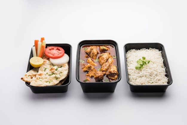 Indian Red Chicken curry packed for home delivery in plastic container