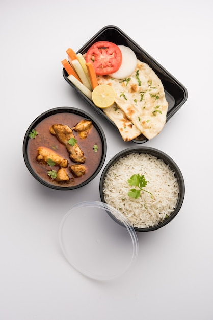 Indian Red Chicken curry packed for home delivery in plastic container