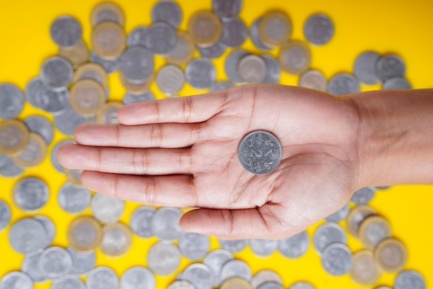 Indian rupees coin holding in women hand