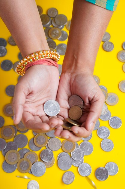 Indian rupees coin holding in women hand