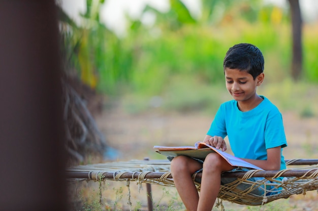 Indian  rural child reading a book