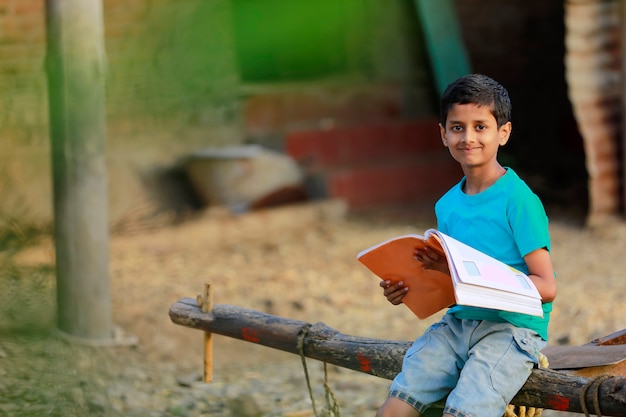 Indian rural child reading a book