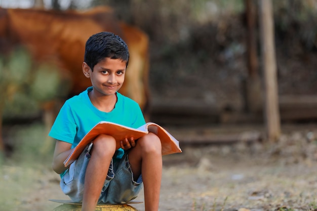 Indian rural child with a book