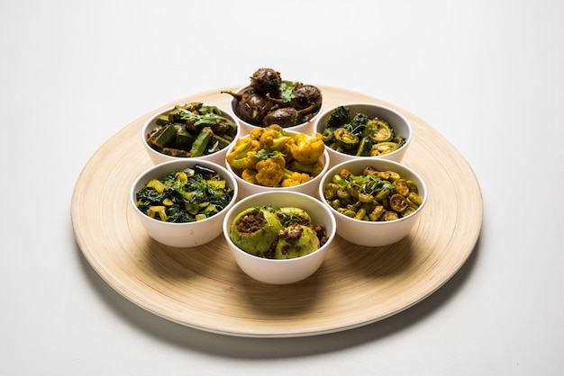 Indian sabzi, vegetable fried recipes served in white bowl over moody or colourful surface. selective focus