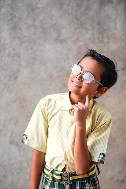 Indian school boy giving thinking gesture