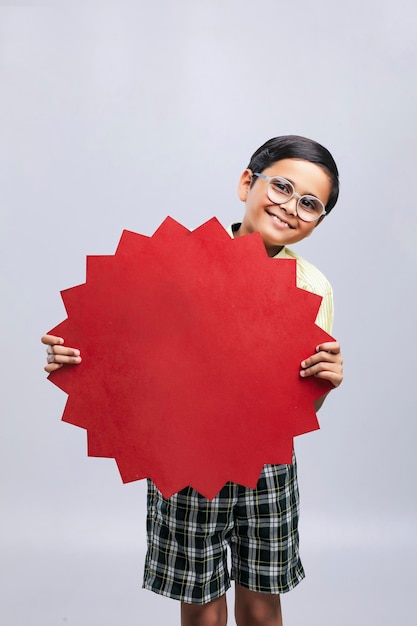 Indian school boy showing board with copy space