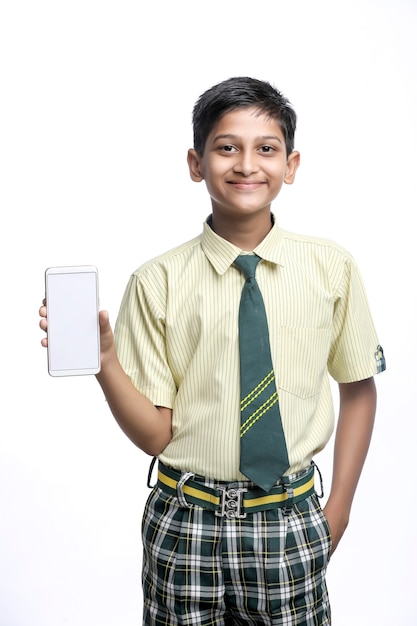 Indian school boy showing smartphone screen. online education concept.