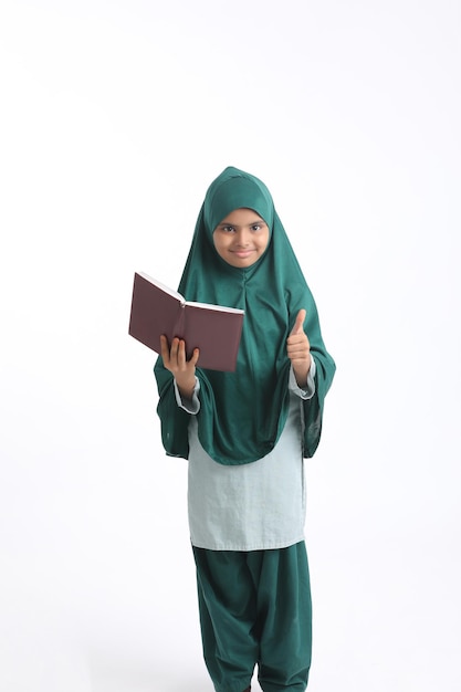 Indian school girl studying on white background