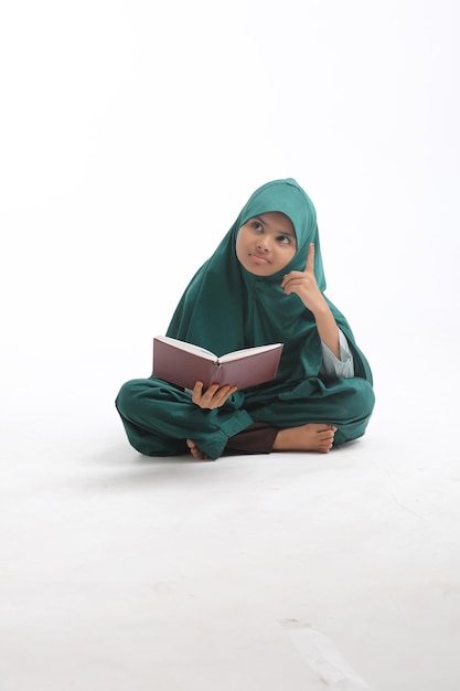 Indian school girl studying on white background