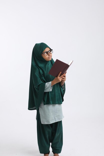 Indian school girl studying on white background