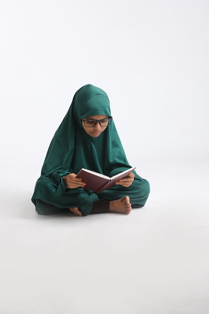 Indian school girl studying on white background