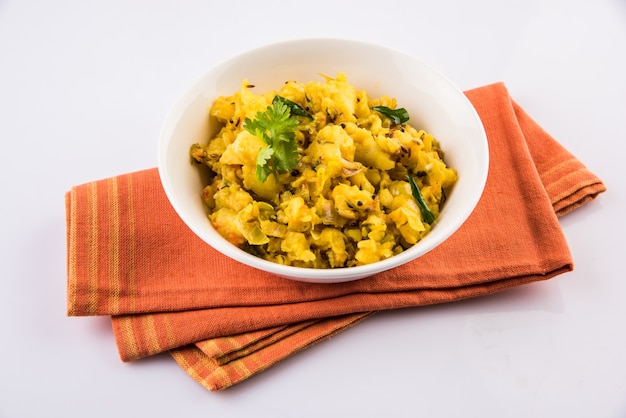 Indian semi dry Potato Spicy recipe also known as Batata bhaji or Aloo ki Sabji, served in a ceramic bowl. Selective focus