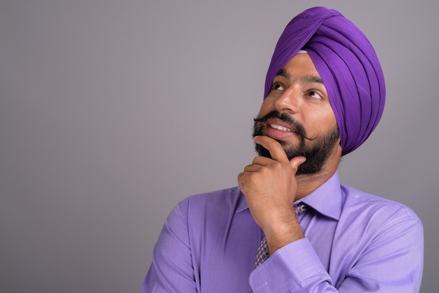 Indian Sikh businessman wearing turban while thinking