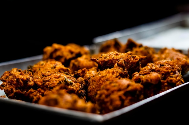 Indian snack made of onion chickpea flour or besan deep dried into mustard oil