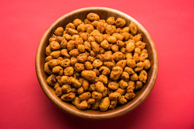 Indian Spiced coated fried and crunchy Masala Peanut. Popular Namkeen snack. served in plate of bowl. selective focus