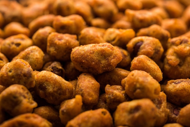 Indian Spiced coated fried and crunchy Masala Peanut. Popular Namkeen snack. served in plate of bowl. selective focus
