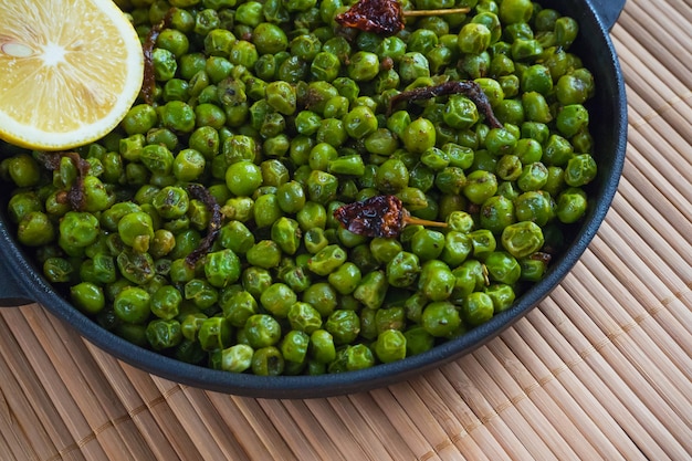 Indian Spiced Peas. Traditional Indian garnish of fried green peas with spices.