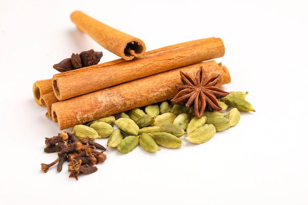 Indian spices and herbs on white surface.