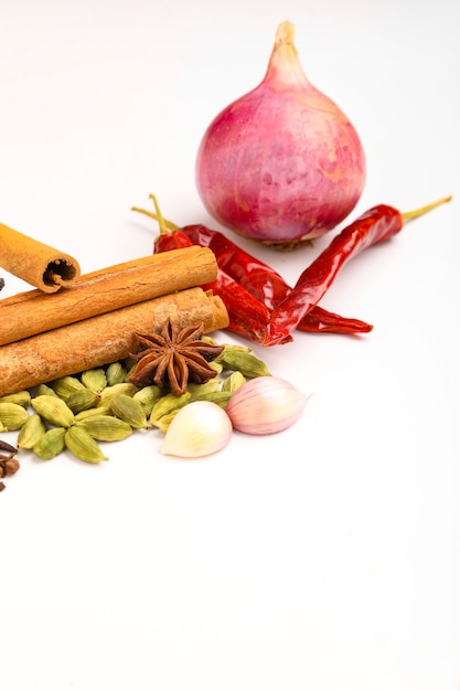 Indian spices and herbs on white surface.