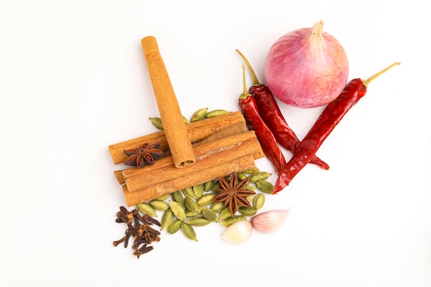 Indian spices and herbs on white surface.