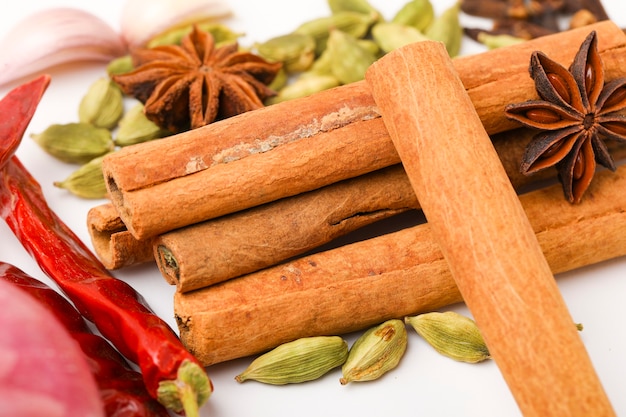 Indian spices and herbs on white surface.