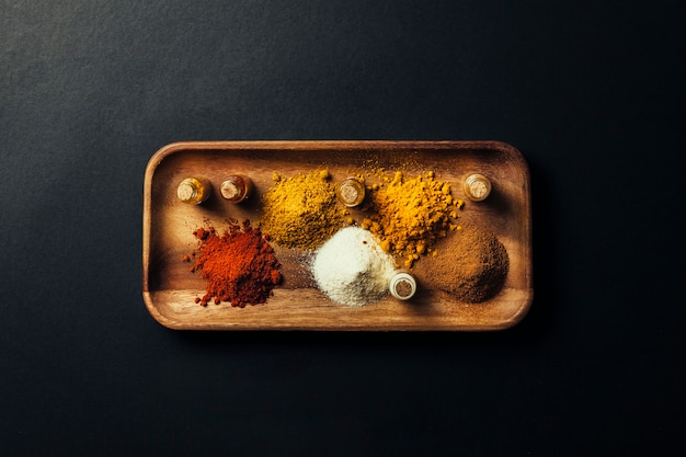 Indian spices on wooden board