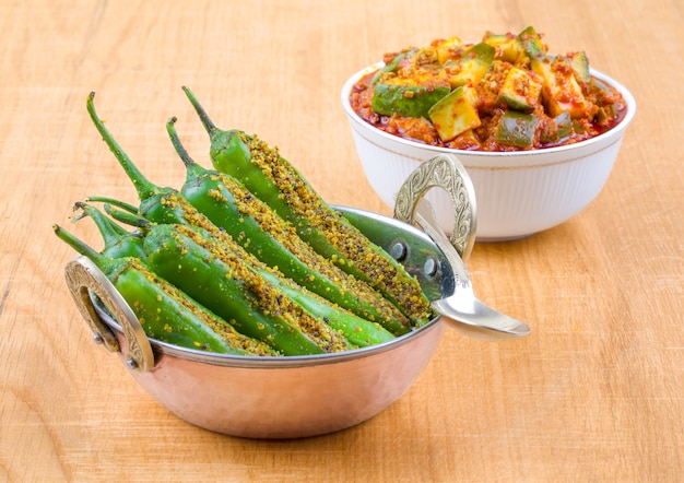 Indian Spicy Green Chilli Pickle with Mango Pickle on Wooden Table