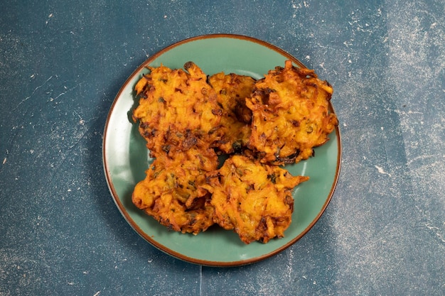 Indian spicy vegetable pakora or pakoda served in dish isolated on table top view