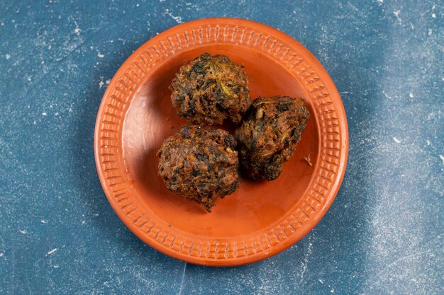 Indian spicy vegetable pakora or pakoda served in dish isolated on table top view