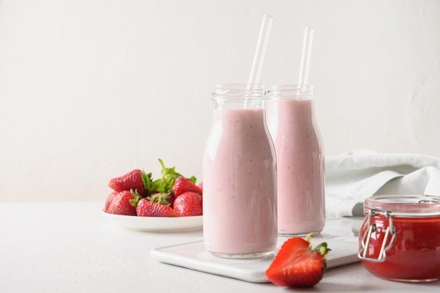 Indian strawberry lassi or milkshake in bottle on white