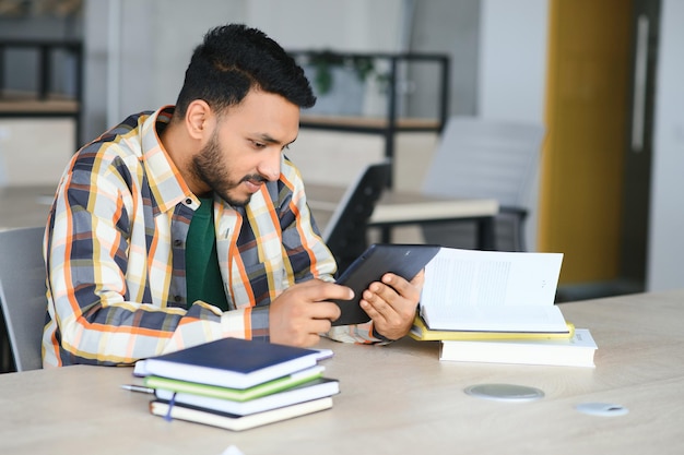 Indian student with books at university