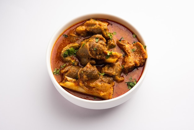 Indian style meat dish or Mutton OR Gosht Masala OR lamb rogan josh served in a bowl, selective focus