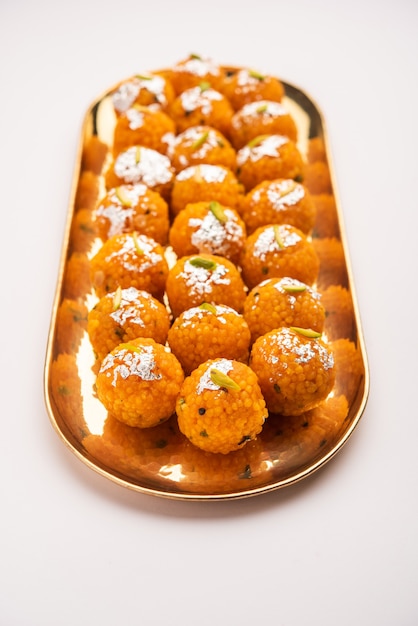 Indian sweet motichoor laddooÃÂÃÂ or Bundi laddu made of gram flour very small balls or boondis which are deep fried and soaked in sugar syrup before making balls