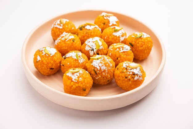 Indian sweet motichoor laddooÃÂÃÂ or Bundi laddu made of gram flour very small balls or boondis which are deep fried and soaked in sugar syrup before making balls