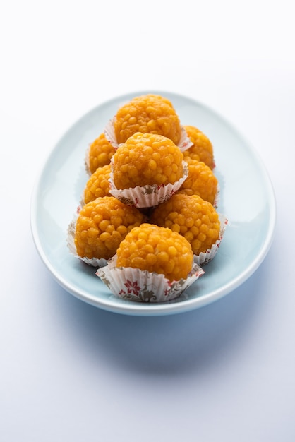 Indian sweet motichoor laddooÂ or Bundi laddu made of gram flour very small balls or boondis which are deep fried and soaked in sugar syrup before making balls