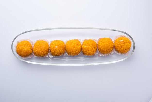 Indian sweet motichoor laddooâ or bundi laddu made of gram flour very small balls or boondis which are deep fried and soaked in sugar syrup before making balls