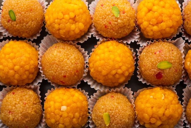 Indian sweet motichoor laddooâ or bundi laddu made of gram flour very small balls or boondis which are deep fried and soaked in sugar syrup before making balls