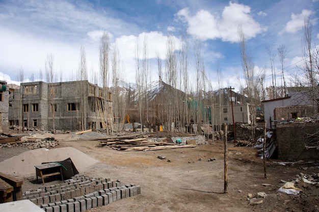 Indian and tibetan people working builder new building house and hotel resort at construction site at Leh Ladakh village in Jammu and Kashmir India while winter season