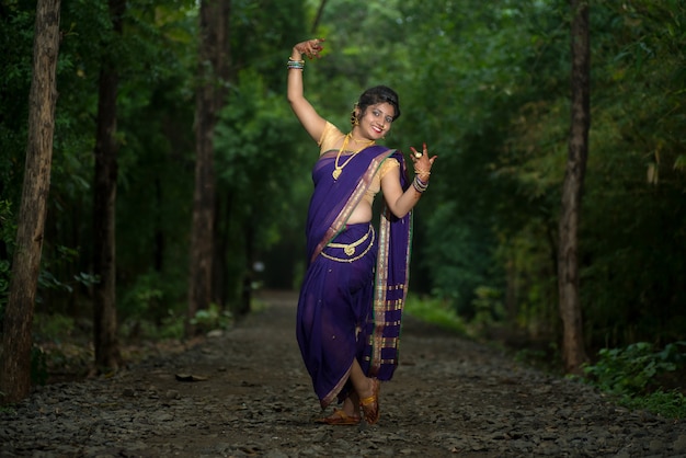 Indian Traditional Beautiful young girl in saree posing outdoors