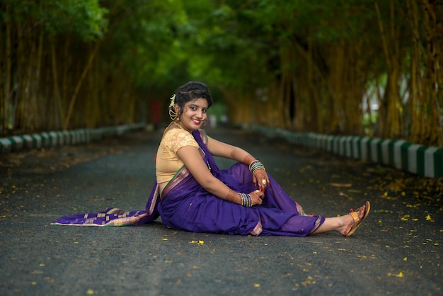 Indian Traditional Beautiful young girl in saree posing outdoors