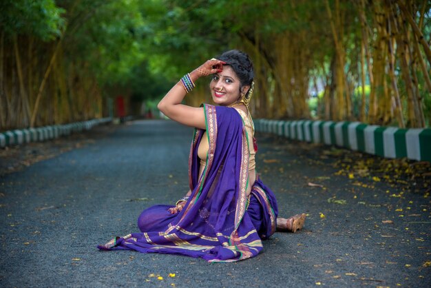 Indian Traditional Beautiful young girl in saree posing outdoors