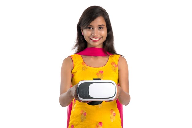 Indian traditional young girl holding and showing VR device