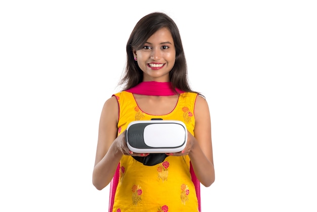 Indian traditional young girl holding and showing VR device