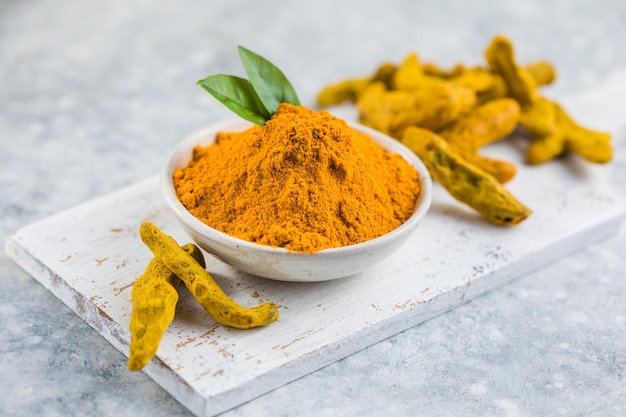 Indian turmeric powder and root. Turmeric spice.