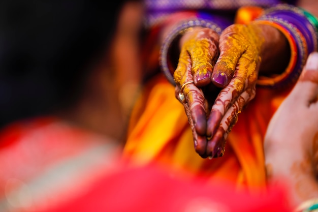 Indian wedding ceremony: bridal hand in haldi ceremony