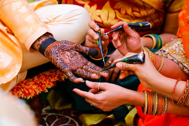 Indian wedding ceremony : groom hand with mehandi design