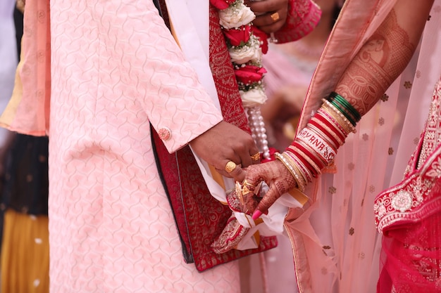 Indian wedding saath phere bride and groom holding hands