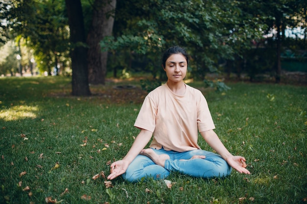 Premium Photo | Indian woman doing yoga in outdoor summer park