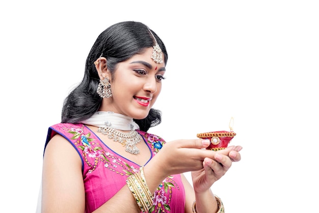 Indian woman holding Diya oil lamps for the Diwali festival