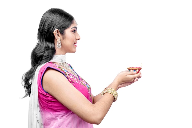 Indian woman holding Diya oil lamps for the Diwali festival